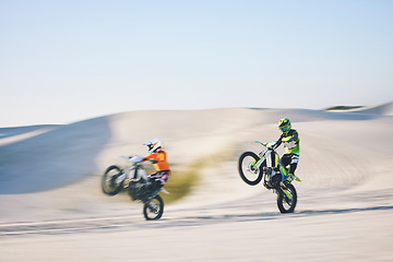 Image showing Speed, desert and people for cycling on a motorbike for travel, sports or freedom. Moving, fast and racers on bikes for adrenaline, challenge or driving on a sand course for adventure or competition