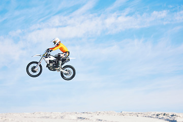 Image showing Motorbike, jump and man in the air with blue sky, mock up and stunt in sports with fearless person in danger with freedom. Motorcycle, jumping and athlete training for challenge or competition