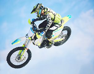 Image showing Motorbike, jump and man in the air with blue sky, mock up and stunt in sports with fearless person in danger with freedom. Motorcycle, jumping and athlete training for challenge or competition