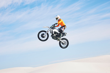 Image showing Motorcycle, jump and man in the air with blue sky, mock up and stunt in sports with fearless person in danger with freedom. Motorbike, jumping and athlete training for challenge or competition