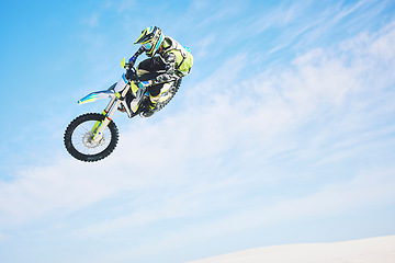 Image showing Motorbike, jump and person in the air with blue sky, mock up and stunt in sports with fearless person in danger with freedom. Motorcycle, jumping and athlete training for challenge or competition