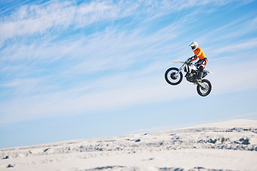 Image showing Motorcycle, desert and jump for sports in race, adrenaline and training for fitness in competition. Athlete, sky and mockup for freedom, driving and dirtbike in outdoor for stunt or performance