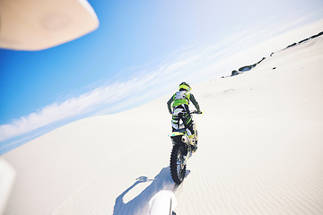 Image showing Desert, back and man on motorcycle for sport, adventure and travel for extreme challenge outdoor. Off road, sand and driver riding motorbike on dirt in nature for action, competition race or freedom