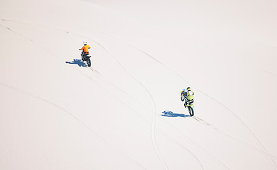 Image showing Motorcycle, desert drive and moto sport with people outdoor on hill with race, journey and adventure. Top view, workout and motorbike challenge of biker with driving exercise and training in Dubai