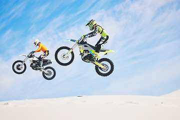 Image showing Jump, people and motorbike with exercise, competition and challenge with safety, fitness and performance. Athletes, sand and bikers with mockup, practice and cycling with freedom, workout and energy