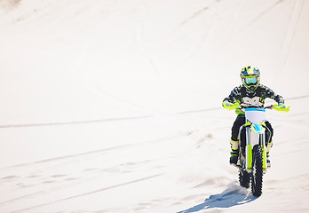 Image showing Man, driving and motorbike on sand for sport, adventure or competition outdoor in summer or mockup space. Motorcycle, ride and athlete on dirt, dune or desert for race, danger and fearless challenge