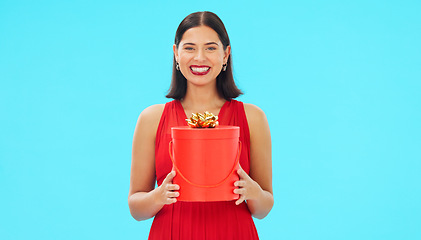 Image showing Birthday present, excited and woman in portrait in studio, celebration and giveaway isolated on blue background. Happiness, smile and winning with gift box, party with reward or bonus prize