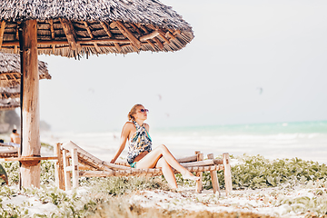 Image showing Woman sunbathing on tropical beach.