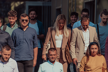 Image showing A diverse group of businessmen and colleagues walking together by their workplace, showcasing collaboration and teamwork in the company.