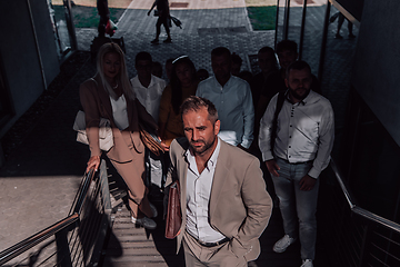 Image showing A diverse group of businessmen and colleagues walking together by their workplace, showcasing collaboration and teamwork in the company.