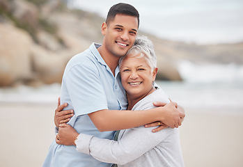 Image showing Man, senior mom or portrait at beach on mothers day for bond, support or love with smile, care or pride. Hug, retirement or mature mother with a happy son at sea together on family holiday vacation