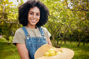 Image showing Woman in orchard, portrait and agriculture with lemon in nature, healthy food and nutrition with citrus farm outdoor. Farmer, picking fruit and smile with harvest, sustainability and organic product
