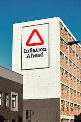 Image showing City, building and warning of inflation, caution and price increase, cost or expenses. Economy recession, apartment billboard and banner in urban town for finance crisis, problem or advertising sign