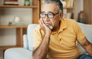 Image showing Face, depression and dementia with a sad old man on a sofa in the living room of his retirement home. Mental health, thinking or alzheimer and a senior person looking lonely with memory nostalgia