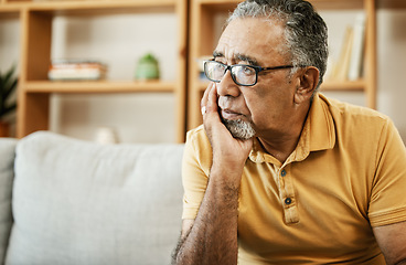 Image showing Face, depression and thinking with a sad old man on a sofa in the living room of his retirement home. Mental health, alzheimer or dementia and a senior person looking lonely with memory nostalgia