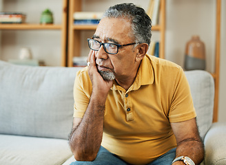 Image showing Face, depression and alzheimer with a sad old man on a sofa in the living room of his retirement home. Mental health, thinking or dementia and a senior person looking lonely with memory nostalgia