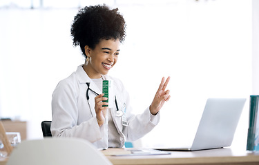Image showing Woman, doctor and laptop with video call at clinic for advice, product or peace sign for healthcare in office. Medic, nurse or pharmacist with box, drugs or emoji for telehealth consultation on pc