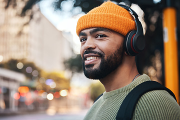 Image showing Smile, music headphones and man in city outdoor, listening to audio or sound track on internet to travel. Radio, streaming podcast and happy person hearing media online, freedom or thinking in street