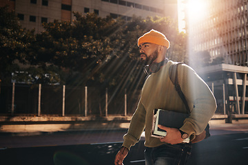 Image showing Man in city street, university books and walking on morning commute to campus for education with backpack. Learning, opportunity and college student on road with school notebook, knowledge and sun.