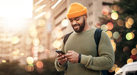 Image showing Phone, man and outdoor chat, network and social media for startup business or freelance marketing in city bokeh. African person typing on mobile for information, contact or travel FAQ in urban street