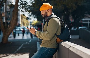 Image showing City, typing and black man with a smartphone, smile and connection with social media, digital app and internet. African person, mobile user and guy with cellphone, website info and outdoor with ideas