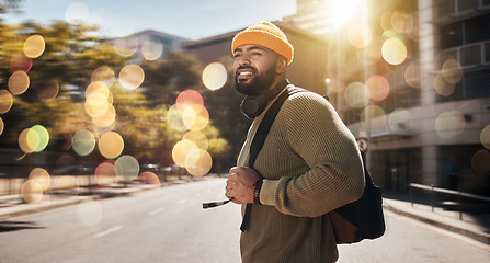 Image showing City, travel and man with banner, walking and travel with student, fashion and casual outfit. Person, stylish and guy on the road, outdoor and bokeh with a cap, trendy and hipster with stylish outfit