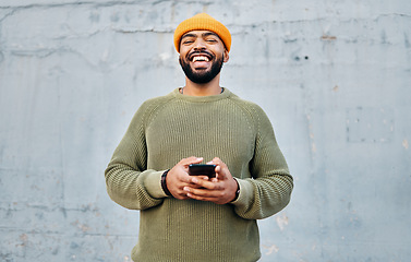 Image showing Phone, happy and portrait of man by wall networking on social media, mobile app or the internet. Technology, smile and person from Colombia scroll on website with cellphone in city by gray background