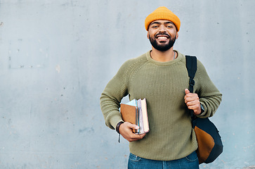 Image showing Student, portrait and backpack with books for scholarship, university or college education and learning on wall background. Happy face of african man with his bag, notebook and studying or research