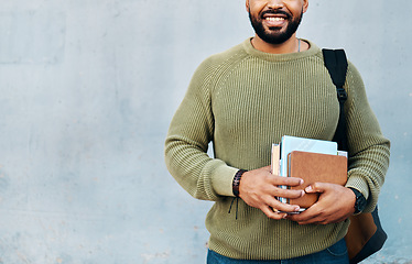 Image showing Man on wall background, university books and smile with mockup on campus for education with backpack. Learn, study and happy college student on grey space with information, knowledge and opportunity.