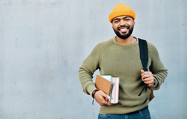 Image showing Backpack, books and student or man on a wall background for scholarship, university or college education and learning. Happy portrait of african person in bag and resources for studying with mockup