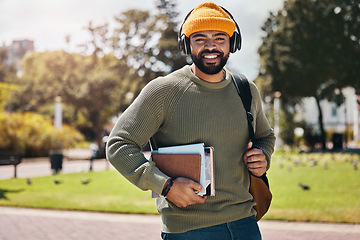 Image showing Student, headphones and backpack on campus of education, college or university podcast in park. Portrait of african man walking, travel and books with audio, electronics or listening to music outdoor
