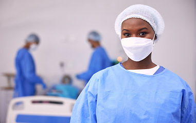 Image showing Portrait, woman and surgeon in operating room, hospital and surgery for medical emergency. Healthcare, african doctor and clinic expert in face mask, scrubs and ppe for working in operation theatre