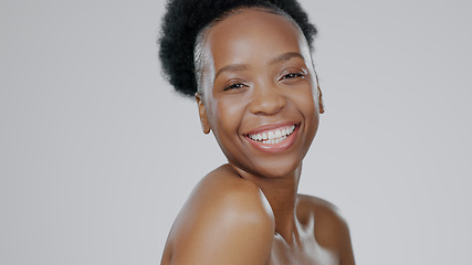 Image showing Portrait, beauty and smile with a happy black woman in studio on a gray background for natural wellness. Face, skincare and cosmetics with a happy young model closeup on space for luxury aesthetic