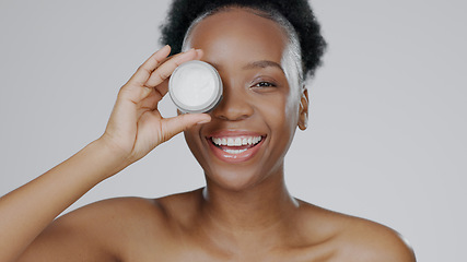 Image showing Happy black woman, portrait and face cream for skincare, beauty or cosmetics against a studio background. African female person or model smile with moisturizer, creme or lotion for facial treatment