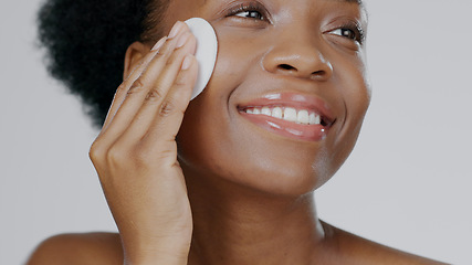 Image showing Face, model and hands with pad for cosmetic, beautiful and happiness in facial cleanse in studio background. Black woman, healthy skin and dermatology for self care, spa treatment or aesthetic mockup