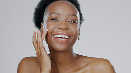 Image showing Happy black woman, portrait and skincare cream for beauty or cosmetics against a studio background. Face of African female person or model smile with lotion, moisturizer or creme for facial treatment