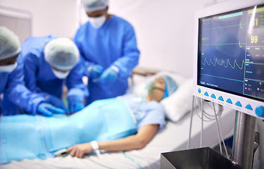 Image showing Monitor, surgery and doctors team doing emergency operation for organ treatment or healing anatomy in hospital. Heart rate, medical and professional surgeon or healthcare teamwork collaboration
