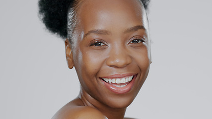 Image showing Portrait, skincare and smile with a happy black woman in studio on a gray background for natural wellness. Face, beauty and aesthetic with a happy young model closeup for antiaging skin treatment