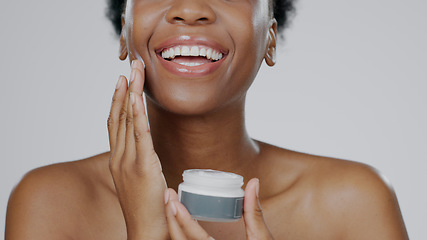 Image showing Black Woman, face cream and skincare with beauty, facial and cosmetic product in container, studio background and smile. Happy, female and healthy skin with moisturizer, cosmetology and dermatology