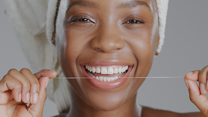 Image showing Portrait, black woman with floss for teeth and dental, health and wellness with beauty on grey background. Oral hygiene, orthodontics and clean plaque away with smile and morning routine in studio