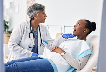 Image showing Dentist, patient and women at clinic, consultation and check mouth for dental health and medical treatment. Oral hygiene, healthcare and surgery, orthodontics and tooth decay with cleaning for cavity