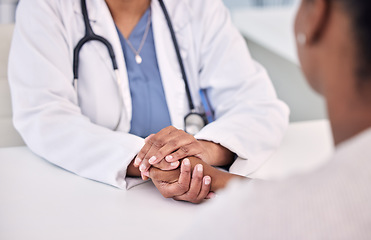 Image showing Healthcare, holding hands and doctor with woman in clinic for support. empathy or care. Checkup, discussion and closeup of female medical worker with sympathy for African patient in medicare hospital