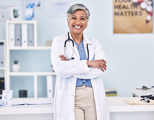 Image showing Happy senior woman, doctor and professional with arms crossed in confidence for healthcare at hospital. Portrait of mature female person, medical expert or surgeon smile for health service at clinic