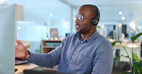 Image showing Call centre, man and headset while talking in office for consultation, telemarketing or customer service. African, person or agent with assistance on website, support or sales with company database