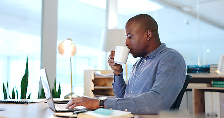 Image showing Office, black man with desk with laptop and coffee, drinking and typing report, review or research article. Computer, internet and businessman with cup of tea writing blog, feedback or online editing