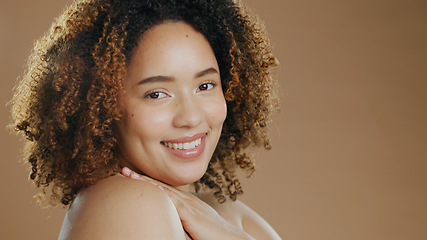 Image showing Portrait of happy woman, natural beauty mockup space or cosmetics for wellness in studio with smile. Skin glow, pride or confident biracial female model with skincare results on a brown background