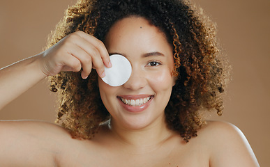 Image showing Happy woman, portrait and cotton pad for skincare, cosmetics or dermatology against a studio background. Face of female person smile with wipe for facial spa treatment, makeup toner or removal