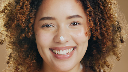 Image showing Skincare, cream and face of happy woman with dermatology, beauty or happiness on brown background in studio. Skin, care or portrait with cosmetics, lotion or sunscreen product for health or wellness