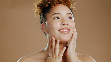 Image showing Woman, beauty and touch face for skincare cosmetics in studio isolated on brown background. Hand, natural and happy model thinking in spa facial treatment for glow, health or wellness of smooth skin