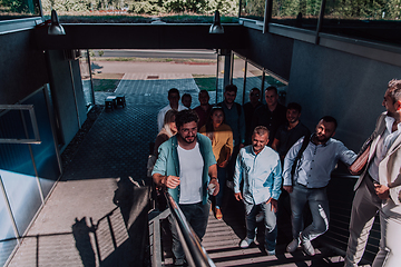 Image showing A diverse group of businessmen and colleagues walking together by their workplace, showcasing collaboration and teamwork in the company.